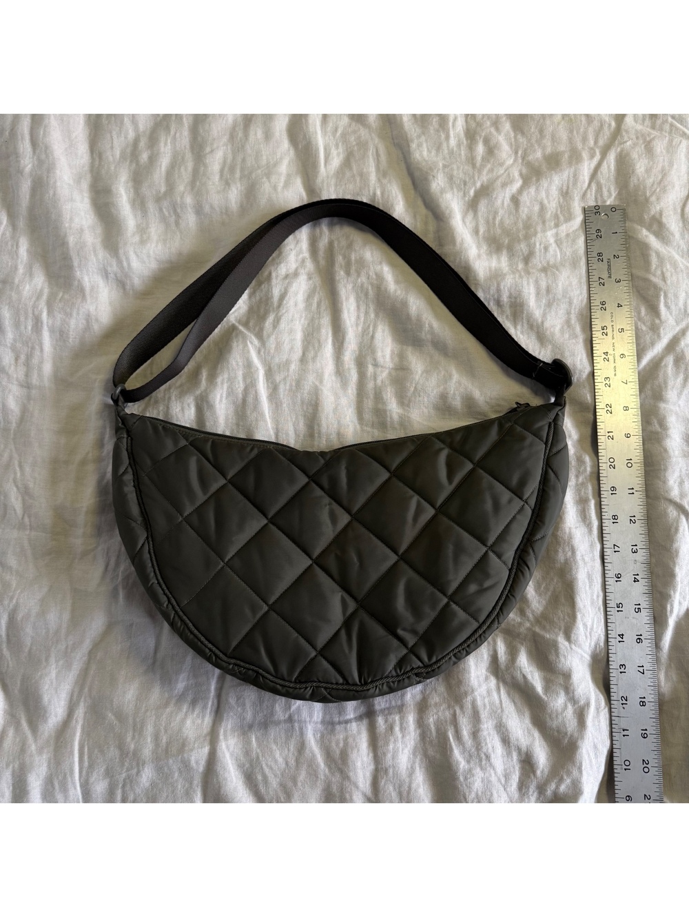 dark green quilted crescent shoulder bag